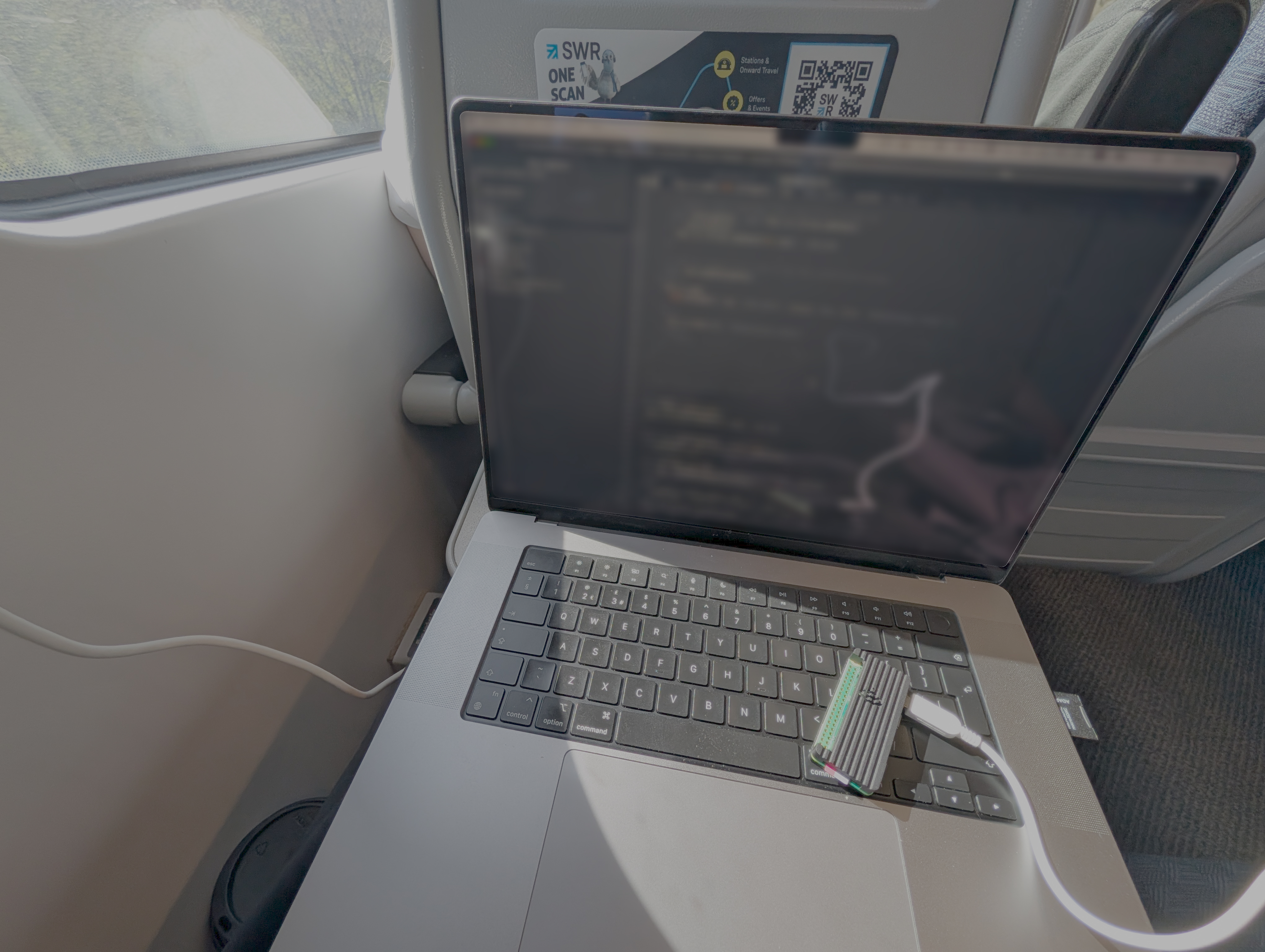 Working on the train down to Southampton — Hub firmware on screen, prototype board on the keyboard